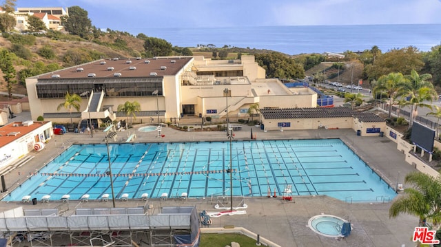 view of pool featuring a water view