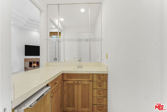 bathroom featuring vanity and a tile fireplace