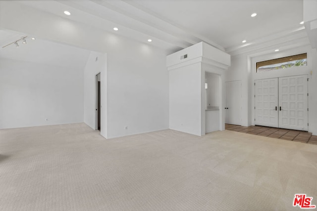 interior space with light colored carpet and rail lighting