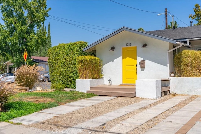 ranch-style house featuring stucco siding