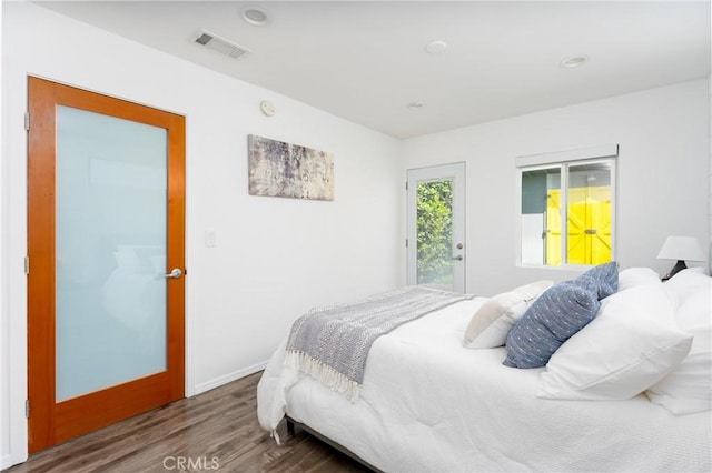 bedroom with access to outside and wood-type flooring