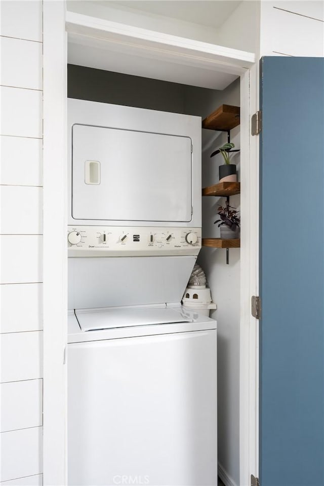 washroom with stacked washer / dryer