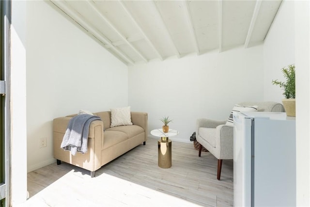 living area featuring hardwood / wood-style floors and beam ceiling