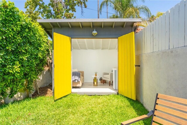 view of outbuilding featuring a lawn