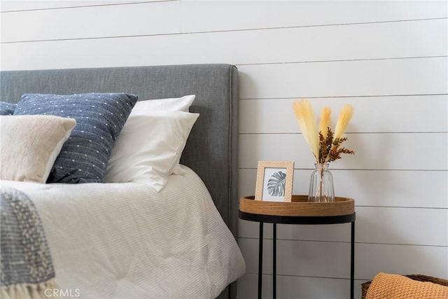 bedroom featuring wooden walls