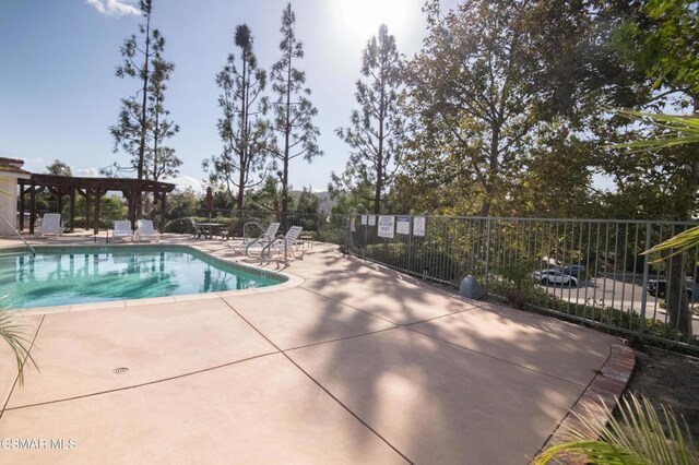 view of swimming pool featuring a patio area and a pergola