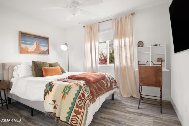 bedroom featuring hardwood / wood-style flooring and ceiling fan