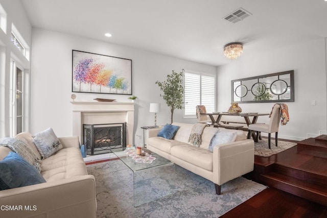 living room with wood-type flooring and an inviting chandelier