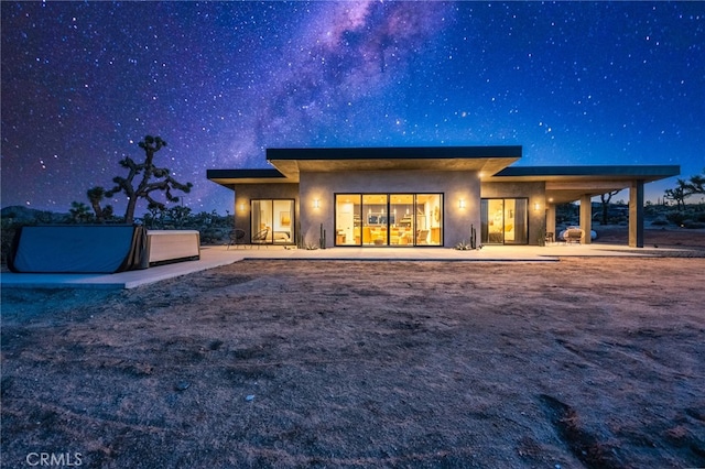 back house at night with a patio area