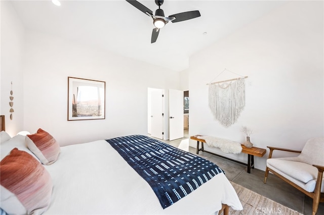 bedroom featuring connected bathroom, lofted ceiling, and ceiling fan