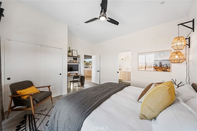 bedroom featuring a closet, ceiling fan, vaulted ceiling, connected bathroom, and hardwood / wood-style flooring