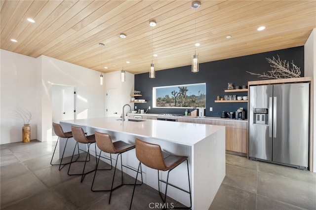 kitchen featuring a large island, wooden ceiling, pendant lighting, and stainless steel fridge with ice dispenser