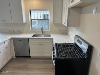 kitchen with white cabinets, dishwasher, black gas stove, and light stone countertops