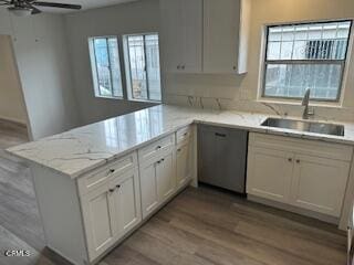 kitchen featuring plenty of natural light, kitchen peninsula, and sink