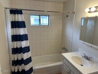 bathroom with vanity and shower / bath combo with shower curtain