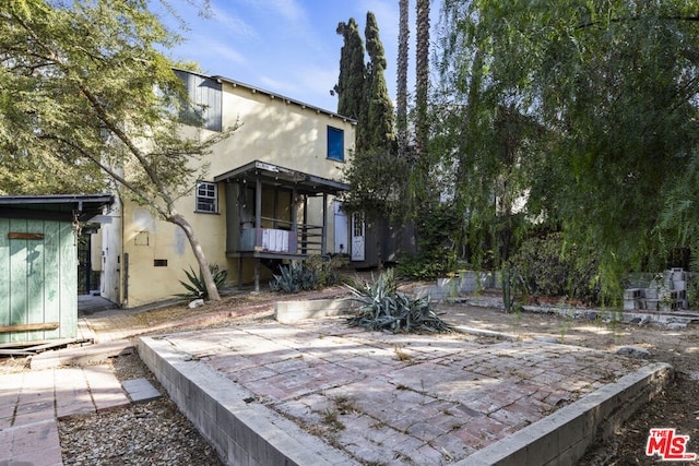 back of house with a patio area