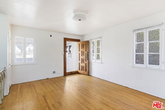 empty room featuring light wood-type flooring and a wealth of natural light