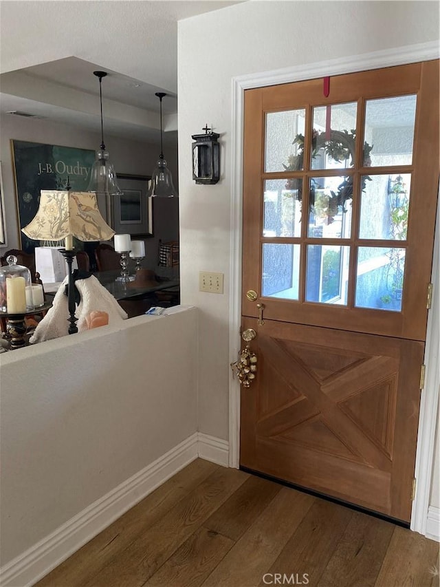 doorway with hardwood / wood-style flooring