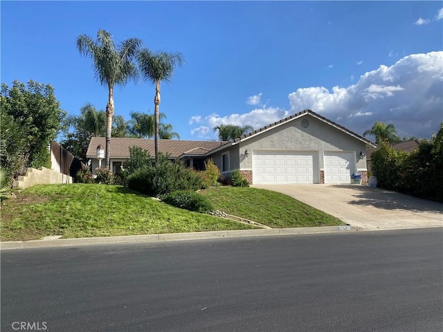 single story home with a garage and a front yard