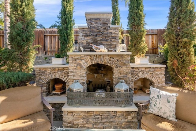 view of patio / terrace featuring an outdoor stone fireplace