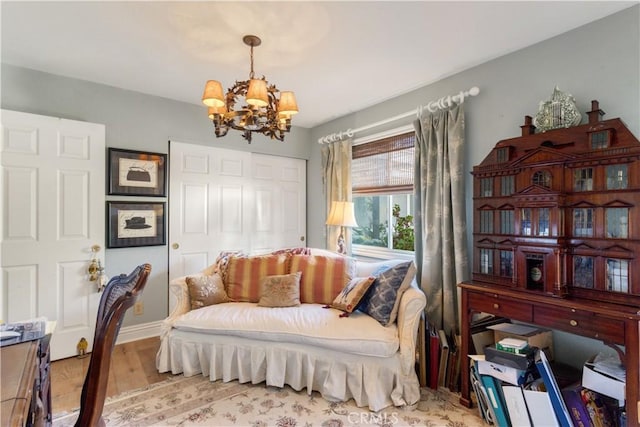 sitting room featuring light hardwood / wood-style floors and an inviting chandelier