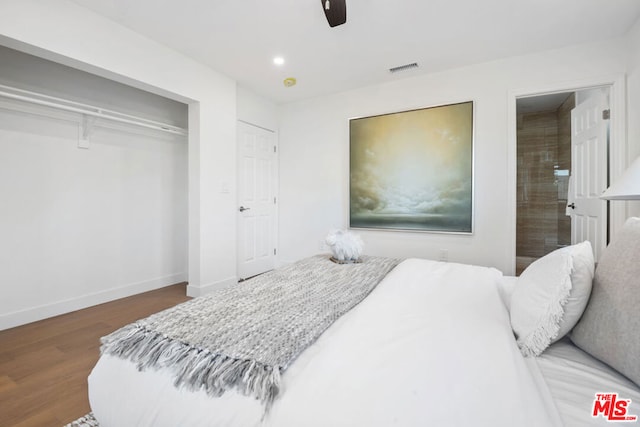 bedroom with ceiling fan, ensuite bathroom, a closet, and hardwood / wood-style floors