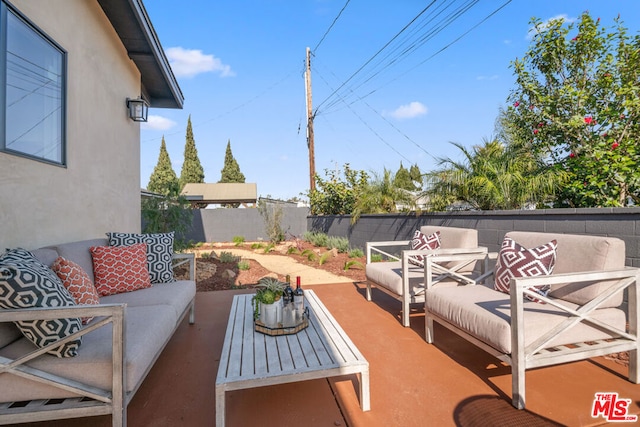 wooden deck featuring an outdoor hangout area and a patio