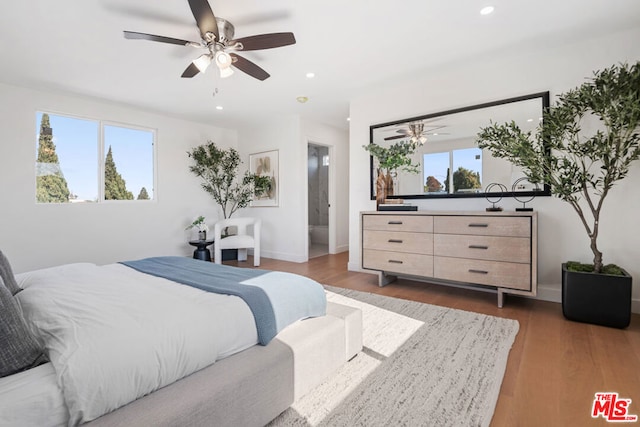 bedroom with ceiling fan and dark hardwood / wood-style flooring