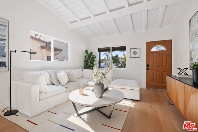 living room with wooden ceiling, lofted ceiling with beams, and light wood-type flooring