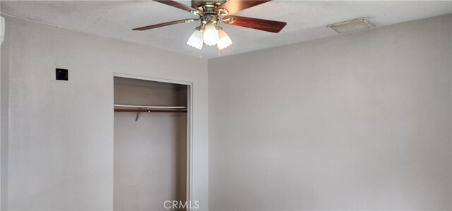 unfurnished bedroom featuring a closet and ceiling fan