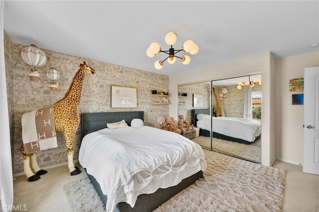 carpeted bedroom featuring a chandelier and a closet