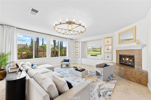 living room with a fireplace and a chandelier