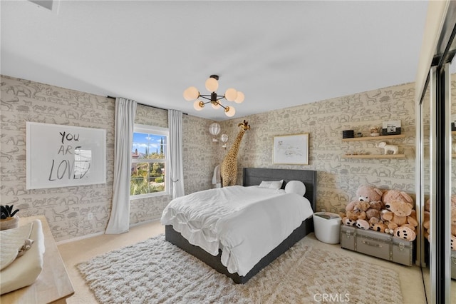 carpeted bedroom with a notable chandelier