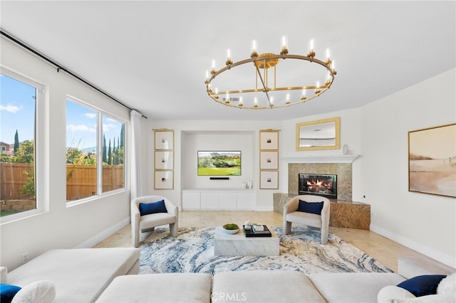 living room with a high end fireplace, carpet floors, and an inviting chandelier