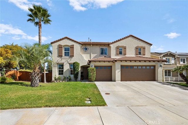 mediterranean / spanish-style home featuring a garage and a front lawn