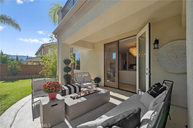 view of patio / terrace featuring an outdoor living space with a fire pit