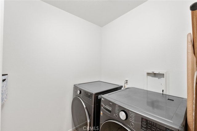 clothes washing area featuring washer and dryer