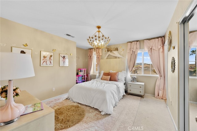 carpeted bedroom with a chandelier