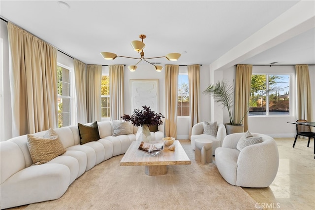 living room featuring a wealth of natural light and an inviting chandelier