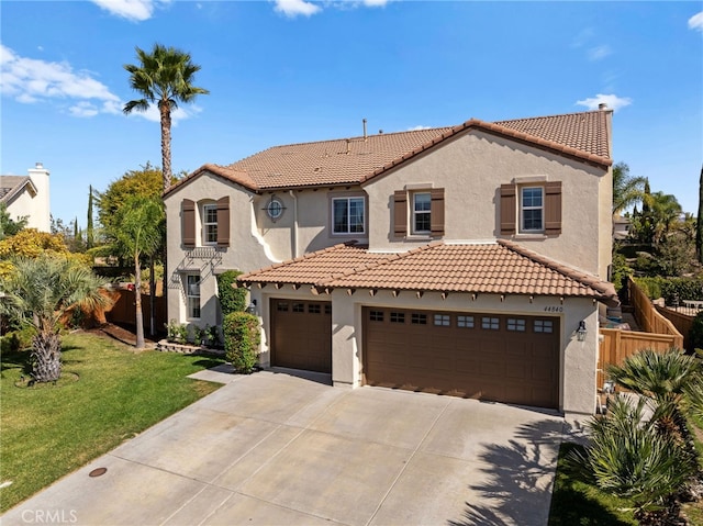 mediterranean / spanish house with a front lawn and a garage