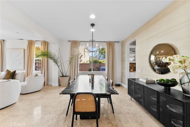 dining area featuring an inviting chandelier