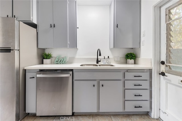 kitchen with gray cabinets, sink, and appliances with stainless steel finishes