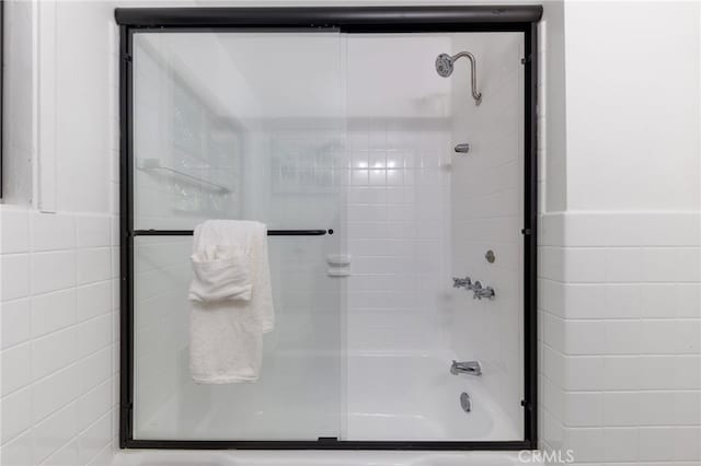 bathroom with shower / bath combination with glass door