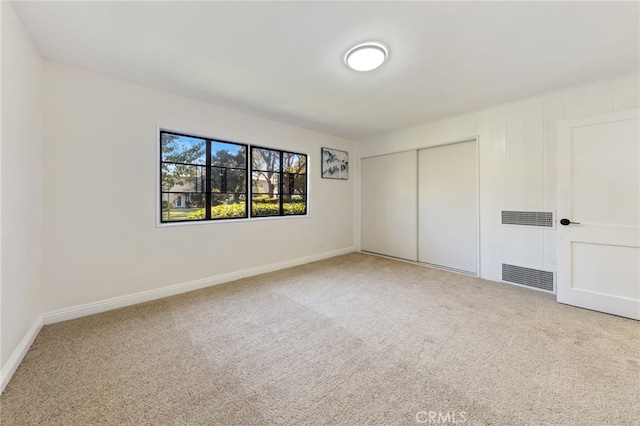 unfurnished bedroom with carpet floors and a closet