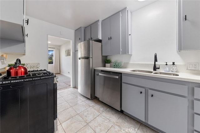 kitchen featuring gray cabinetry, sink, and stainless steel appliances