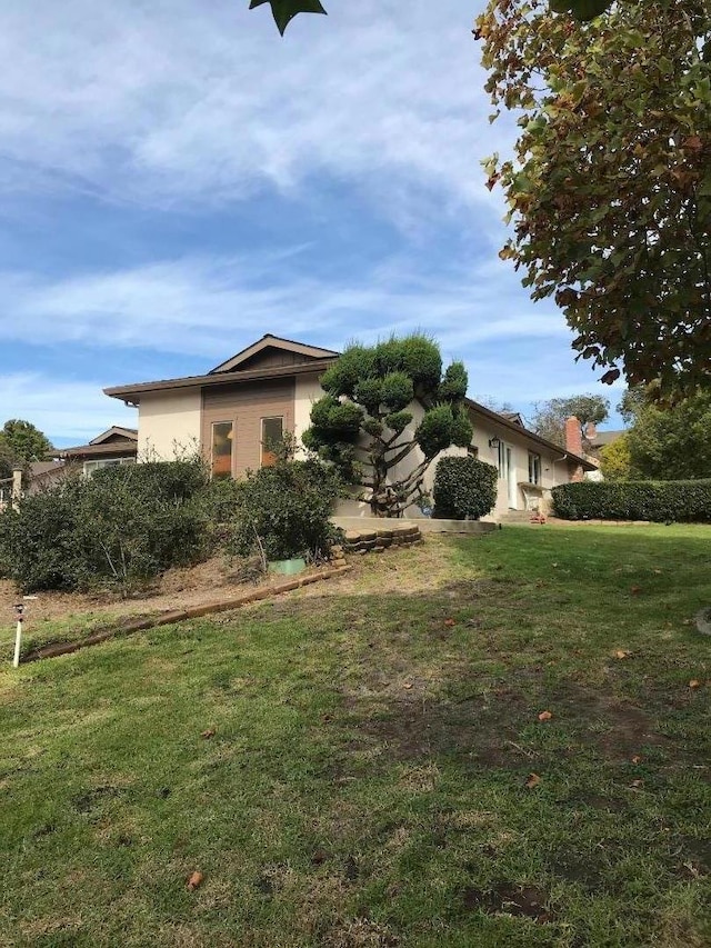 view of side of property with a lawn