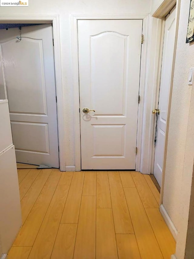 corridor featuring light hardwood / wood-style floors