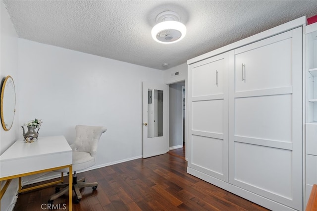 office area featuring dark hardwood / wood-style flooring and a textured ceiling