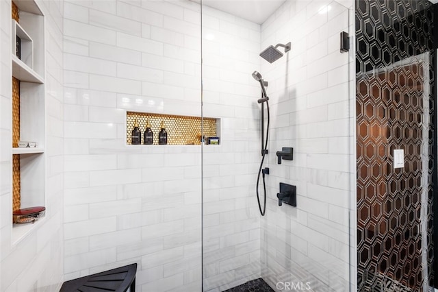 bathroom with a tile shower