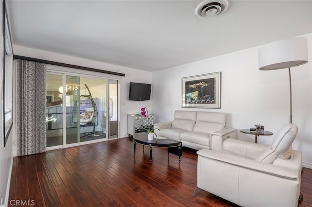 living room with dark hardwood / wood-style flooring